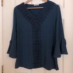 Women’s top w/bell sleeves and crocheted accents.